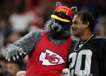 LAS VEGAS, NEVADA - NOVEMBER 14: A Kansas City Chiefs fan and Las Vegas Raiders fan talk during the second half of a game at Allegiant Stadium on November 14, 2021 in Las Vegas, Nevada.